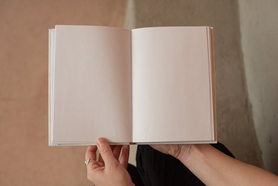 Hands holding an open blank notebook, perfect for concept or design projects with ample copy space.