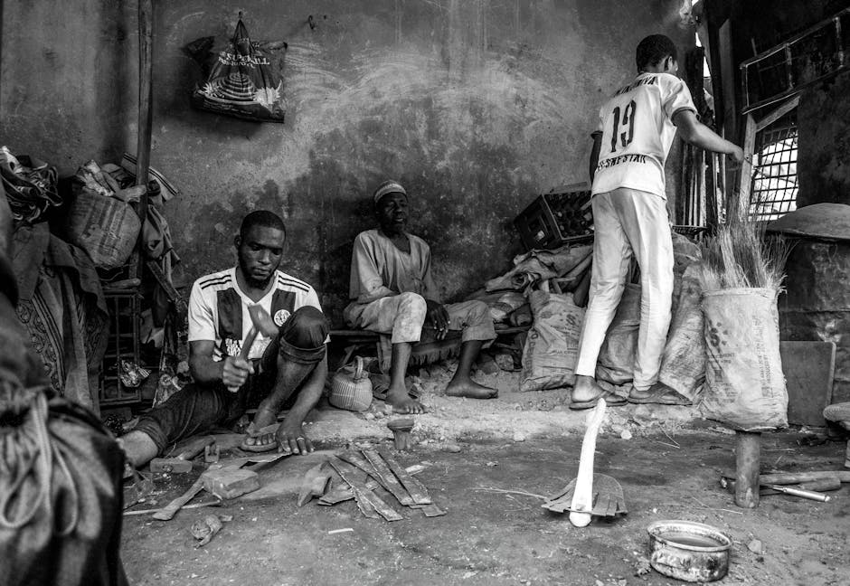 Three men in an urban workshop, engaging in crafts and repairs.